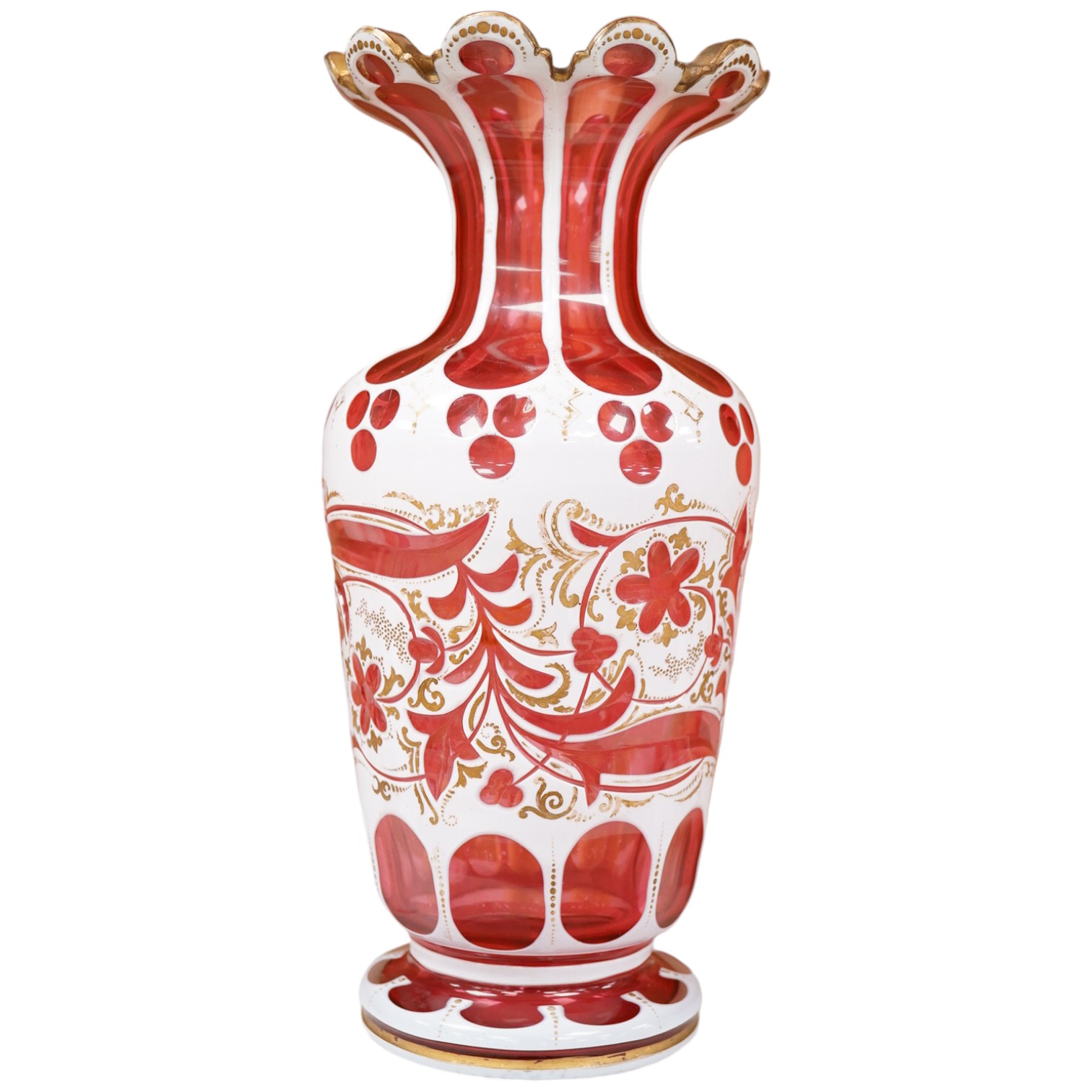 A 19th century Bohemian overlaid and gilt decorated cranberry glass vase, 29cm high. Condition - gilt decoration worn in places